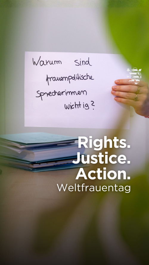 Ein Schild ist im Bild zu sehen. Darauf ist der Schriftzug "Warum sind frauenpolitische Sprecherinnen wichtig?" zu lesen.