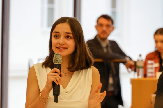 Debattantin spricht in Mikrofon